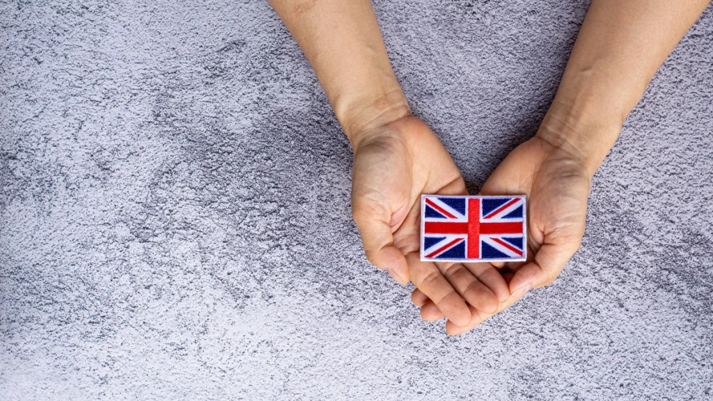 2 hands holding a Union Jack flag