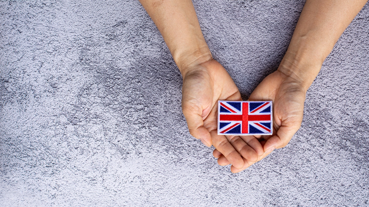 2 hands holding a Union Jack flag